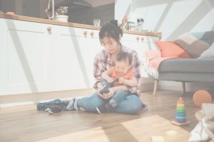 Parent calmly helping a frustrated toddler get dressed, illustrating the difference between conscious parenting and gentle parenting through empathy and healthy boundaries.